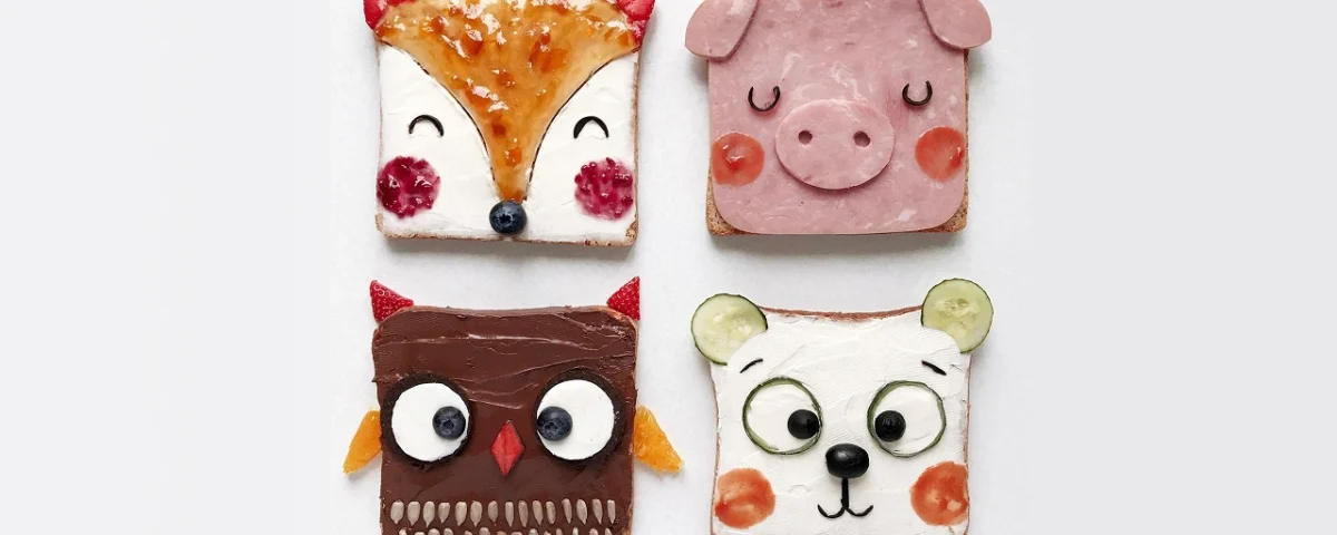 Fette di pane decorate con ingredienti colorati per rappresentare animali come volpe, maiale, gufo e orso, create dall’artista Daryna Kossar